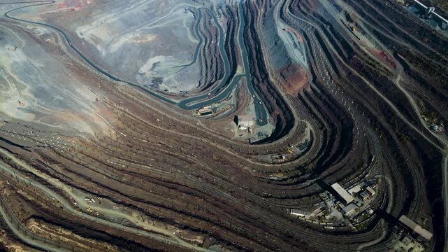 Iron ore mining, mineral deposits, excavation work, drone view.