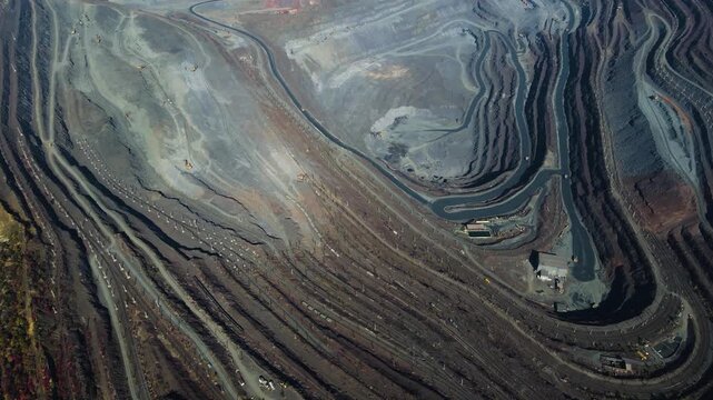 Iron ore mining, mineral deposits, excavation work, drone view.