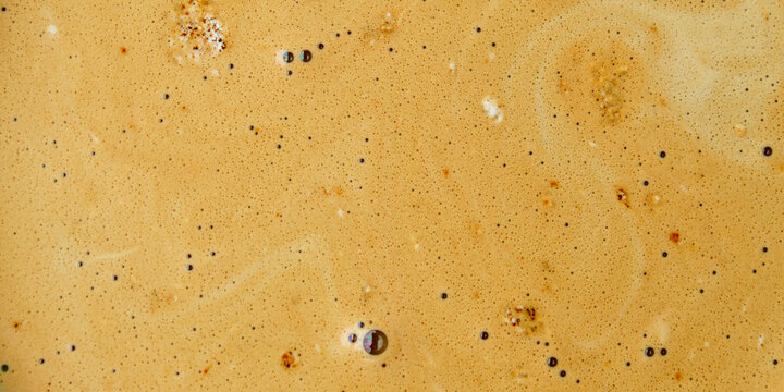 golden foam or cream texture on top of freshly brewed espresso coffee
