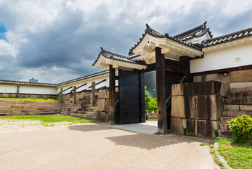 Nice view on the impressive Osaka Castle with its green roof tiles and golden ornaments, Osaka, Japan