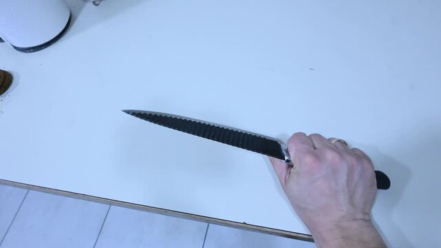 Person Picking Up a Knife by Hand &mdash; Close-Up 1