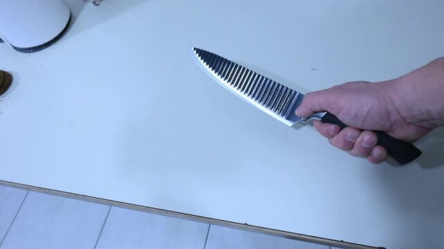 Person Picking Up a Knife by Hand &mdash; Close-Up 3