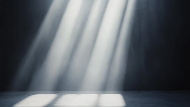 Light beams falling from above into a dark, empty concrete room, creating distinct rectangular window patterns on the textured floor and wall, symbolizing hope, spirituality, or a new beginning