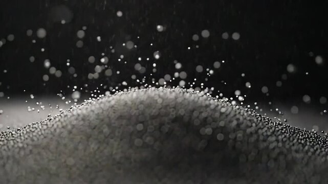 Abstract scene showing countless metallic particles forming a small mound, captured mid vibration with some floating in the air, symbolizing motion, energy, and physical dynamics