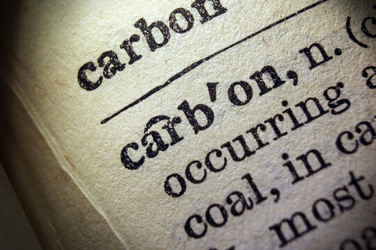 Word carbon printed on dictionary page, macro close up
