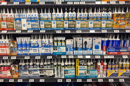Frisco, Texas, USA - September 12th, 2025: Well-stocked Walmart aisle with a wide selection of caulk tubes, silicone sealants, and adhesives from brands like GE, DAP, Loctite, Gorilla, and Alex