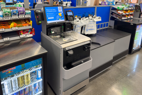 Frisco, Texas, USA - September 12th, 2025: Modern self-service checkout machine in Walmart with scanner, payment terminal and screen prompting to scan items