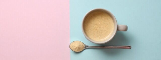 Obraz premium Coffee cup with spoon of powdered colostrum supplement on pastel background for wellness trend. banner 