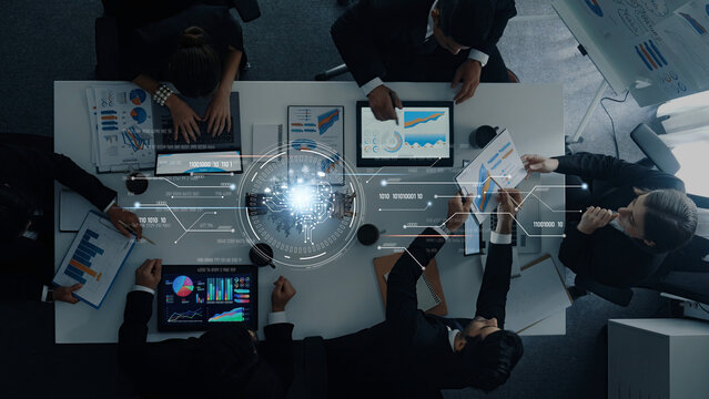 A diverse team of business professionals engages in a data analysis meeting, utilizing charts and technology in a modern office environment to drive innovative solutions. Trope