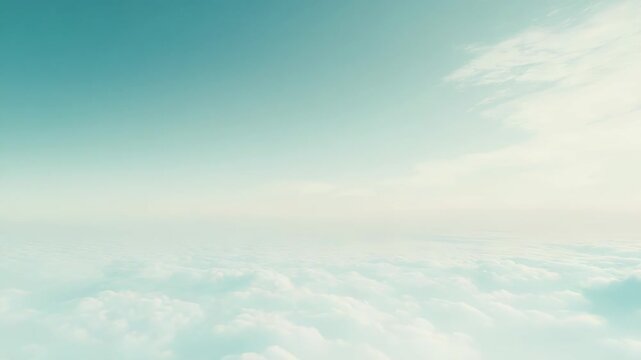 Aerial landscape showing a serene skyscape with fluffy white clouds extending to the horizon under a clear blue green sky, creating a calming atmospheric background