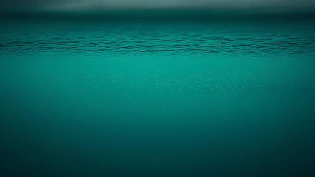 Vast tranquil turquoise ocean meeting a soft, blurred cloudy sky at the horizon, a minimalist seascape with gentle blue green gradient and calm, dreamy atmosphere