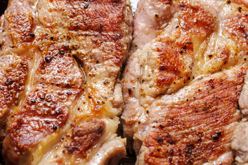 Close up texture of fried pork steak with golden brown crust. Cooked savory meat dish background.