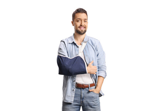 Cheerful young man with a broken arm wearing an arm sling