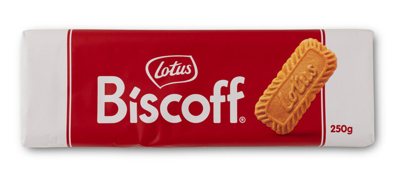 A pack of Lotus Biscoff cookies sits on a white background. The pack has a red color with a clear display of the brand name. The weight shows 250 grams