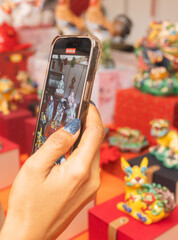 Chinese New Year market featuring traditional Asian talismans, including feng shui items, candles, dragons, lucky cats, jade ornaments, coins, souvenirs celebrating prosperity and good fortune.
