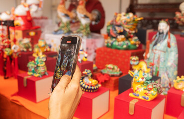 Chinese New Year market featuring traditional Asian talismans, including feng shui items, candles, dragons, lucky cats, jade ornaments, coins, souvenirs celebrating prosperity and good fortune.