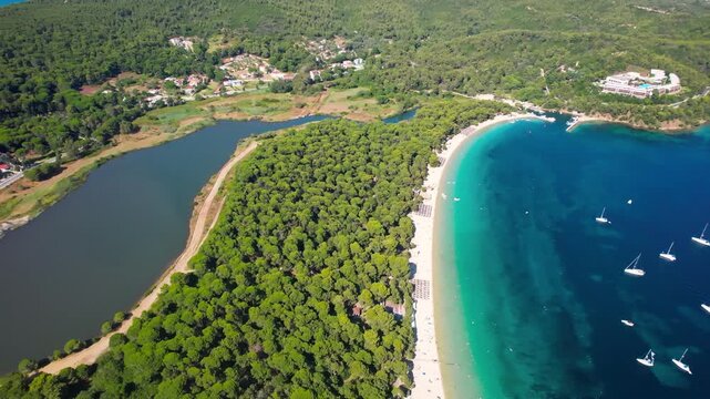 Aerial 4K Top-Down View of Koukounaries Beach and Strofilia Lake Lagoon &mdash; Golden Sand, Pine Forest and Turquoise Sea Landscape in Skiathos Island Greece