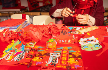 Chinese New Year papercutting workshop - create traditional festive symbols and Chinese characters from red paper. Cultural craft activity celebrating Lunar New Year traditions