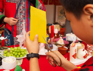 Chinese New Year candle workshop - create traditional festive symbols and Chinese characters from red paper. Cultural craft activity celebrating Lunar New Year traditions