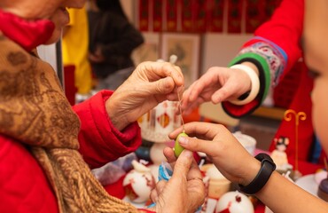 Chinese New Year candle workshop - create traditional festive symbols and Chinese characters from red paper. Cultural craft activity celebrating Lunar New Year traditions
