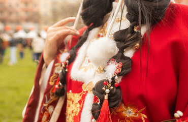 Traditional Chinese clothing at the fair. Lunar New Year parade, Asian community. Festive atmosphere, cultural diversity. Ideal for travel, culture, festival promotion and editorial design
