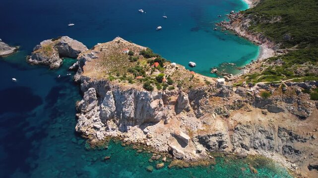 Aerial 4K Orbit View of Kastro Peninsula and Majestic Double Sea Cliffs &mdash; Revealing Scenic Coastline and Pristine Beaches of Skiathos Island in Sporades Greece