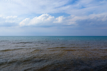 Expansive Open Water Landscape Under Blue Sky and Clouds