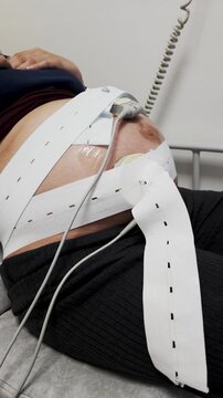Pregnant woman receiving cardiotocography test in hospital