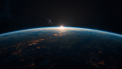 Obraz premium 地球の明暗境界付近で衛星群が夜明けの光を受け始める