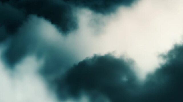 Dark storm clouds gather on one side, creating a moody contrast with lighter, ethereal cloud formations on the other side, forming an abstract and atmospheric weather background