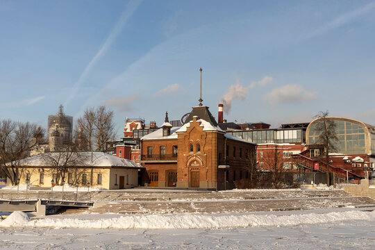 Moscow, Russia, 4 January 2026, View of the historic Krasny Oktyabr district and surrounding buildings behind snowy mounds on a clear winter day in Moscow.