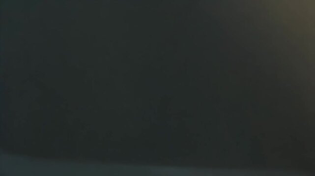 Narrow abstract hallway featuring parallel textured walls and floor with dramatic geometric shadows and bright natural light streaming from a hidden source, suggesting hope and a path forward