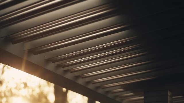 Modern pergola structure showing architectural design with slatted roof details, warm sunbeams creating glowing bokeh light from the outdoor background, inviting relaxation