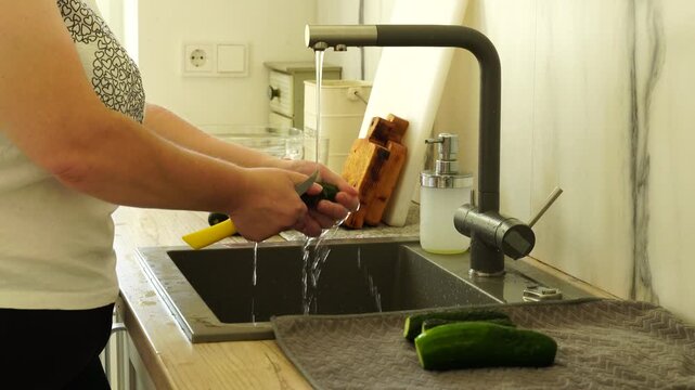Woman washing vegetables before cooking
