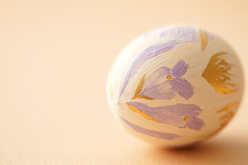 Ornate Easter egg with hand-painted floral motifs in lavender and gold