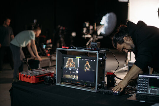 Film set, monitors and modern shooting equipment. Filming crew, lighting devices, monitoring, playback - filming equipment and a team of professionals in filming movies, ads and TV series.