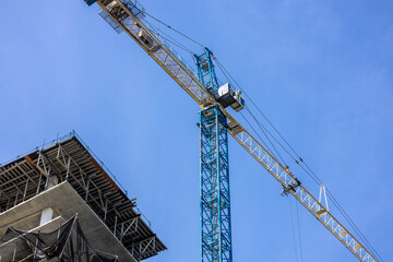 Blue Tower Crane and High-Rise Building Under Construction © Michael