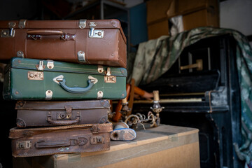 Stacked retro suitcases in an attic setting, evoking travel, history, and nostalgia