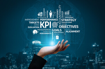 This image features a hand reaching towards a cluster of floating words that symbolize key business...