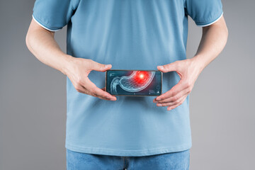 Man holding smartphone with digital stomach scan showing pain and inflammation, telemedicine concept