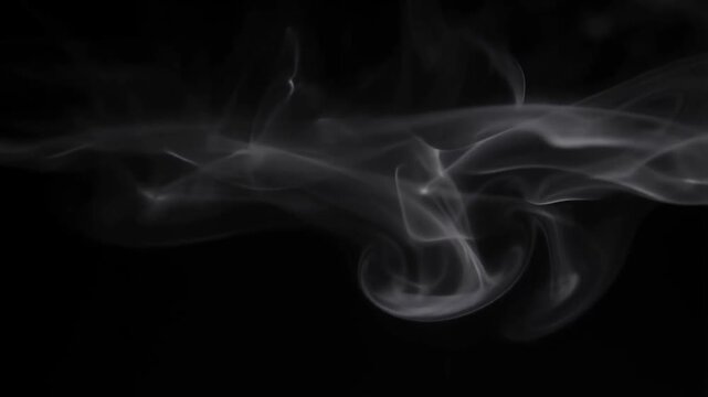 White wispy smoke flowing and swirling gently against black background with translucent layers and fluid motion video footage