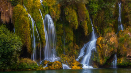 Kravica Waterfall Flowing Over Moss