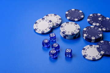 Casino dice and chips on a colored background, poker, gambling with bets. Dice and chips