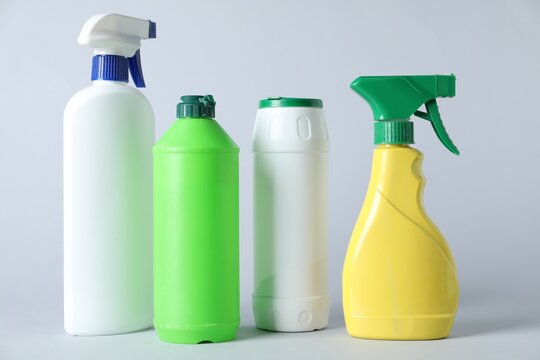 Plastic packaging. Set of detergent bottles on grey background, closeup