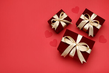 Saint Valentine's day. Beautiful gifts and decorative hearts on red background, flat lay. Space for text