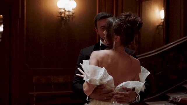 Couple dances in grand hall during evening celebration