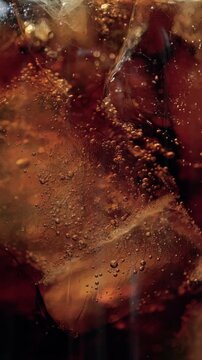 Refreshing fizzy cola soda with ice cubes