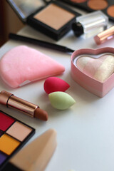 Various colorful cosmetic products on white background. Selective focus.