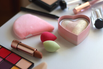 Various colorful cosmetic products on white background. Selective focus.