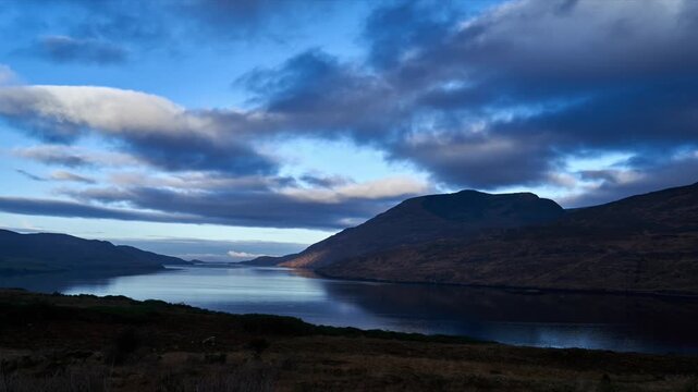 Time-lapse of candy floss clouds over the mountains. Shot during daytime with some amazing mountains in the backdrop. High quality Full HD footage